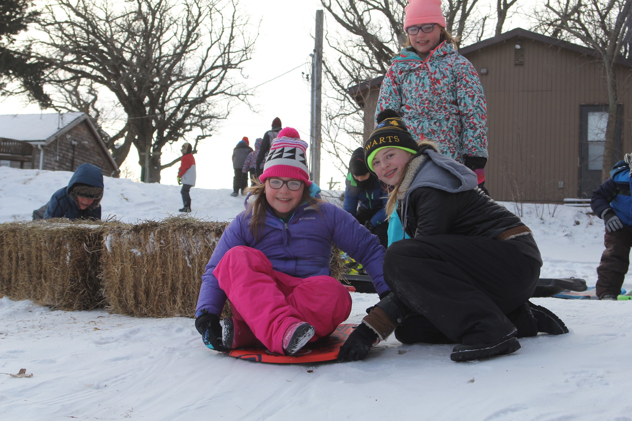 A camper poses on a disk sled just before taking off with assistance from an SK