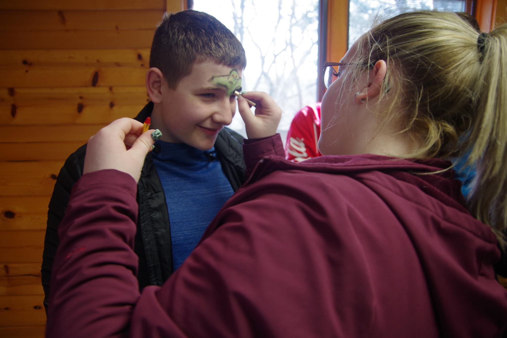 A camper gets his face painted