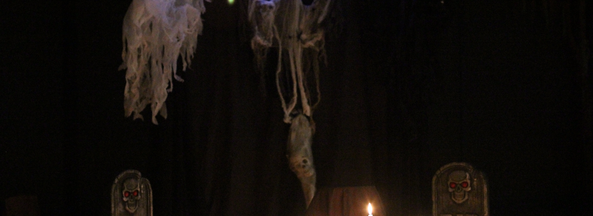 A scene with tombstones and light up bones for a storyteller to share a spooky story