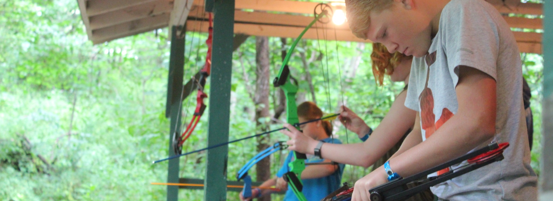 Ranch Campers nock arrows as they prepare to shoot archery