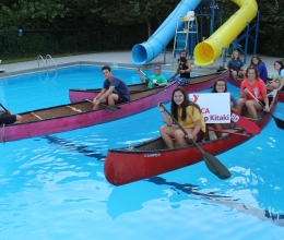 The Niobrara Cabin Group takes their cabin photo in canoes in the pool