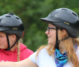 Challenge ranch campers look out on horseback